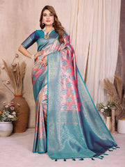 Woman wearing a blue and pink saree with a decorative border in a room setting.