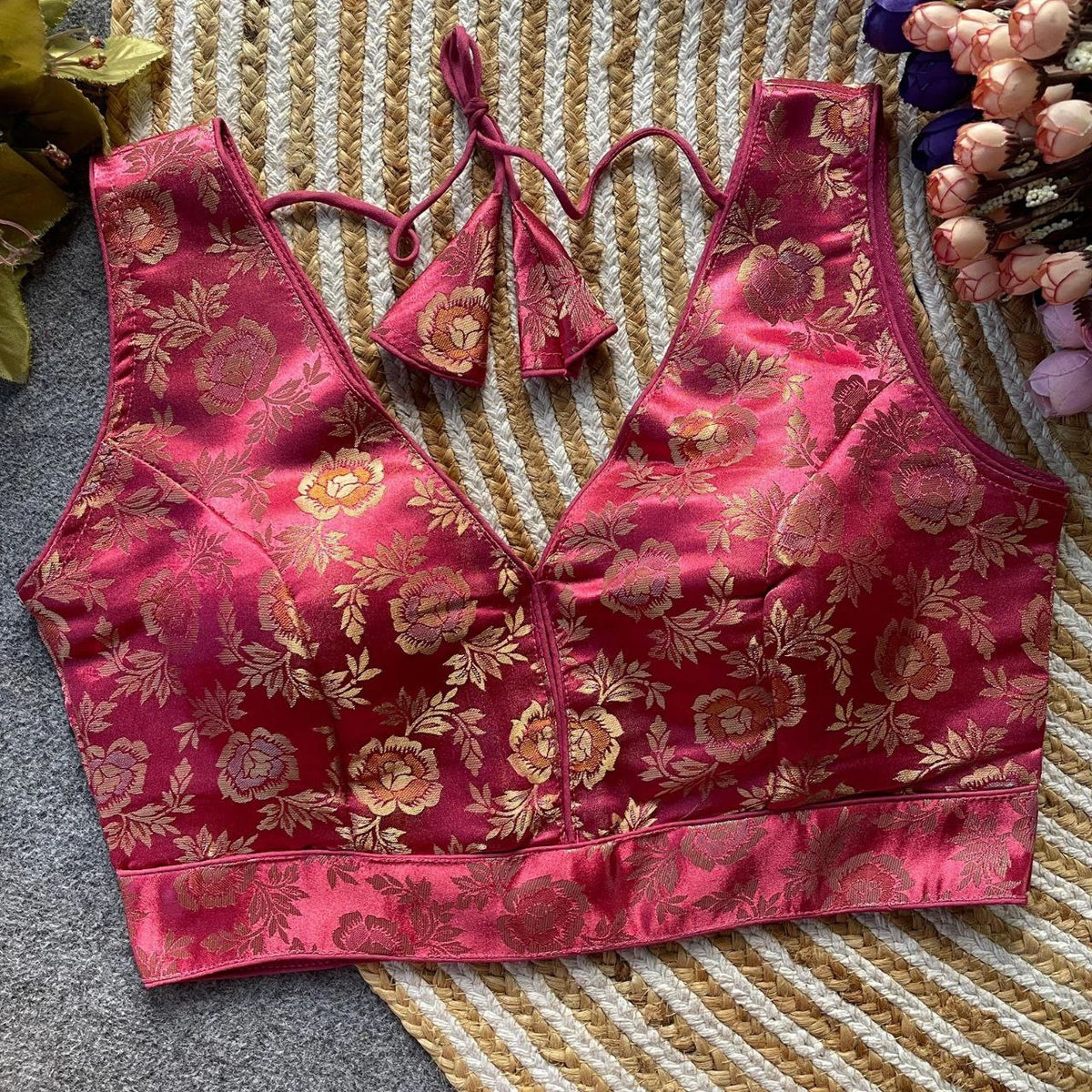 Pink floral brocade bralette on a textured surface