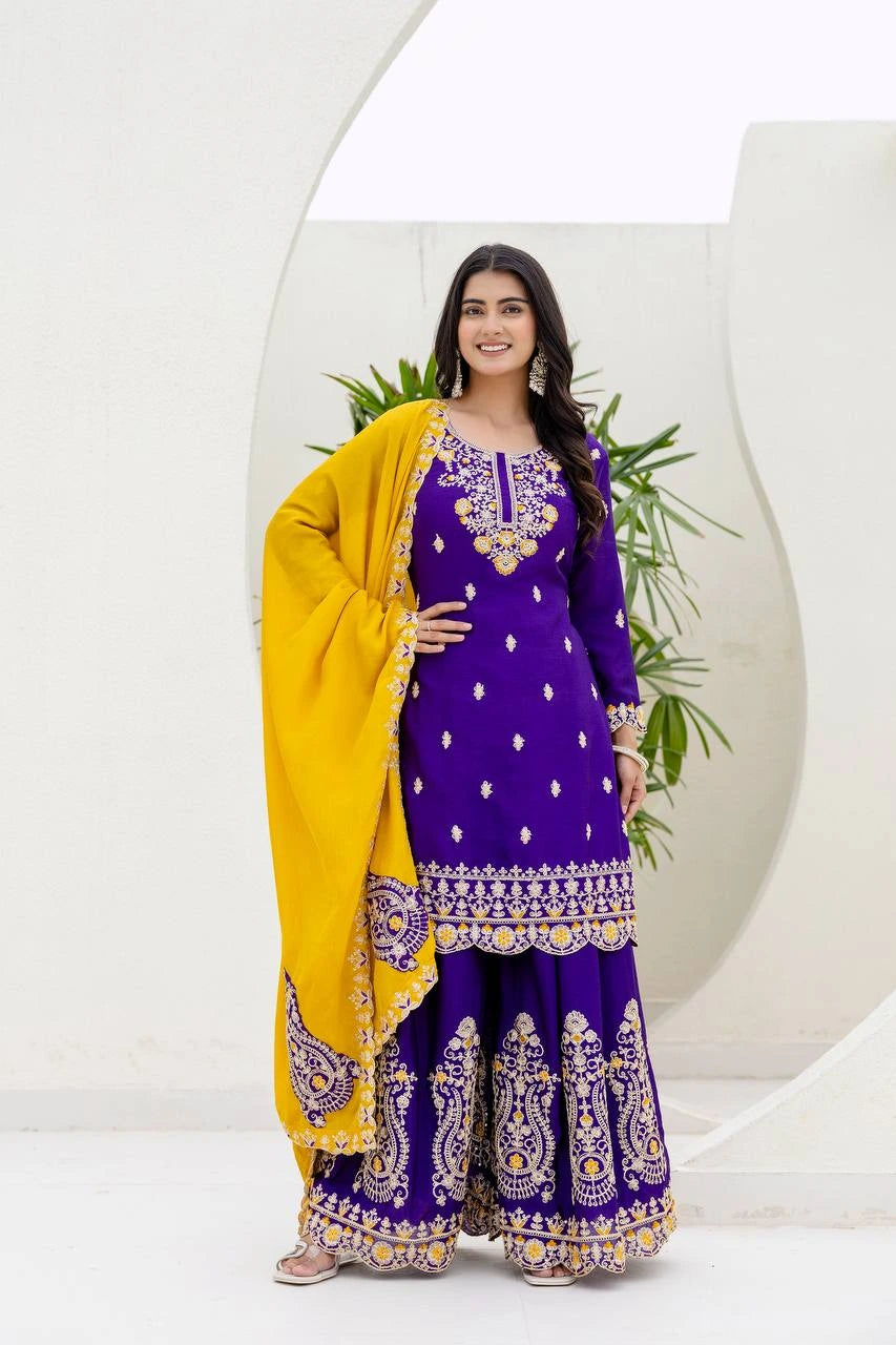 Woman in a purple traditional outfit with yellow dupatta against a white background