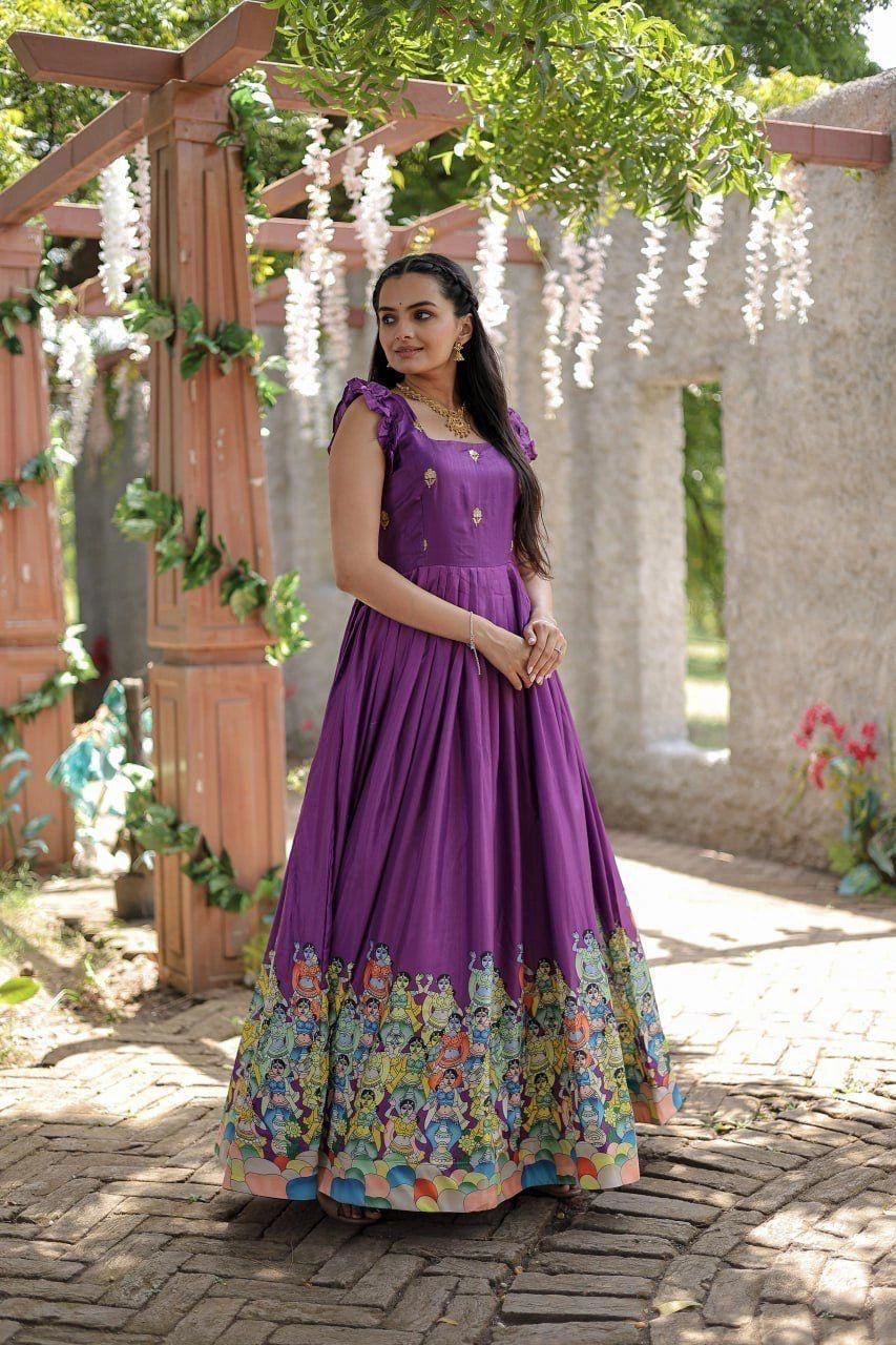 Woman in a purple dress with floral patterns standing outdoors.