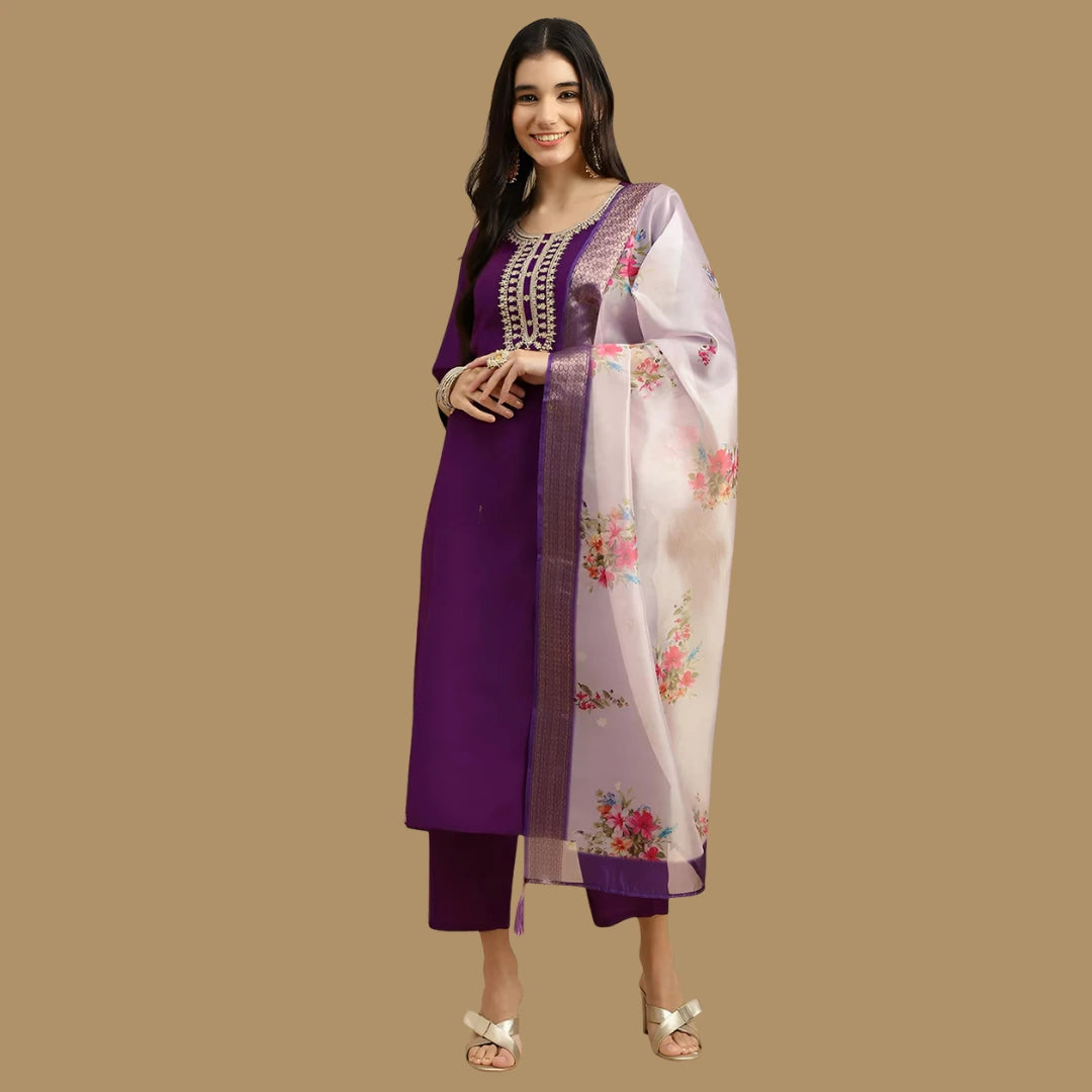 Woman wearing a purple outfit with a floral scarf on a beige background