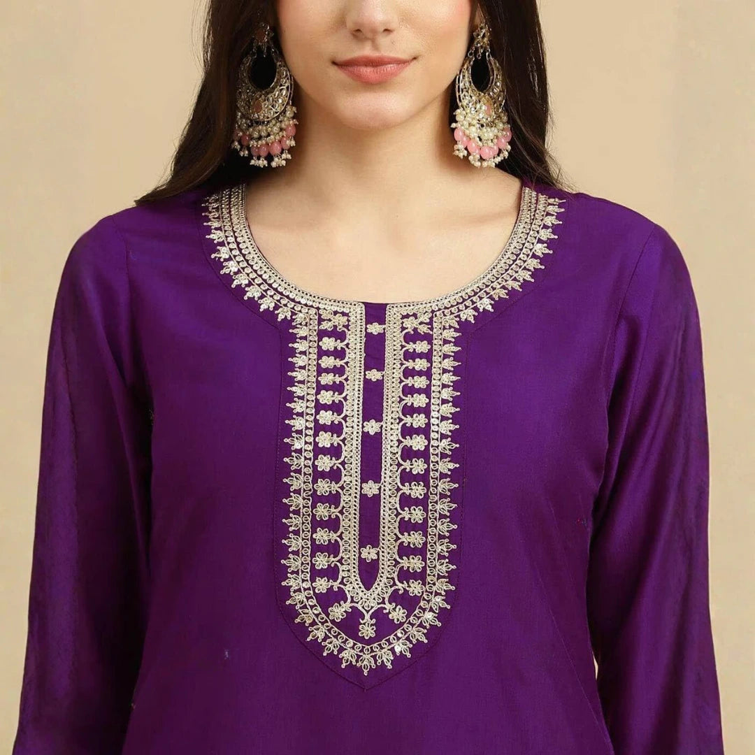 Purple kurta with intricate silver embroidery on a beige background