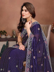 Woman wearing a purple embroidered saree with a neutral background