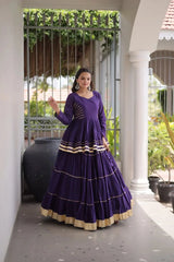 Stunning Purple Ethnic Lehenga Choli with Tiered Flared Skirt, Golden Lace Borders, Full Sleeves, and Elegant Festive Wear Look
