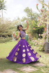 Gorgeous purple lehenga with shimmering mirror embellishments and golden accents delivers timeless festive charm and sophistication.