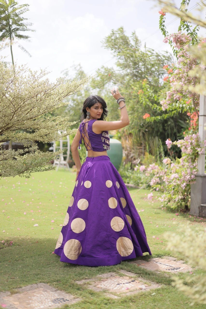 Eye-catching golden circular foil patterns enhance the flowing skirt with a bold and festive appeal.