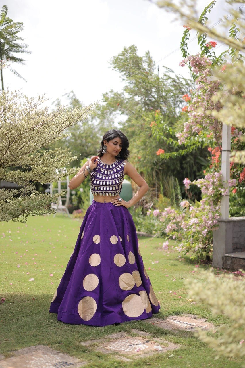 Sleeveless embellished blouse with intricate mirror work creates a stunning and celebration-ready look.