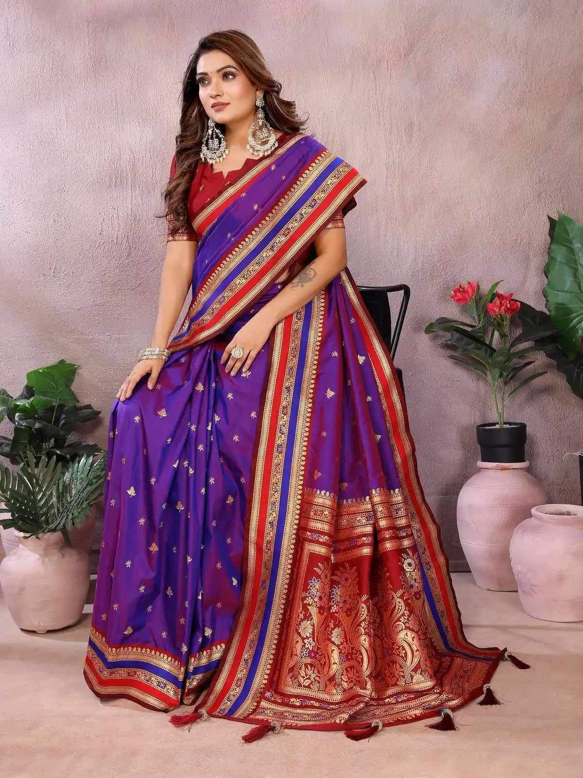 Woman wearing a colorful saree with a neutral background