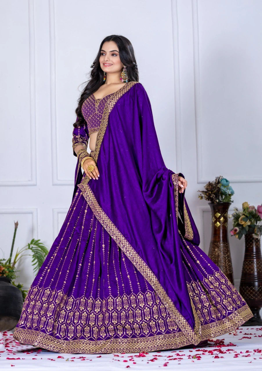 Woman wearing a purple embroidered saree with a white wall background