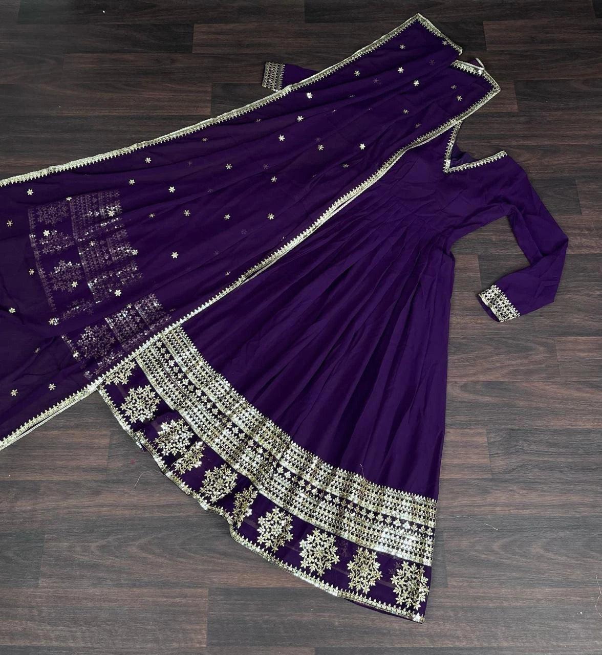 Purple saree with silver embroidery on a wooden surface