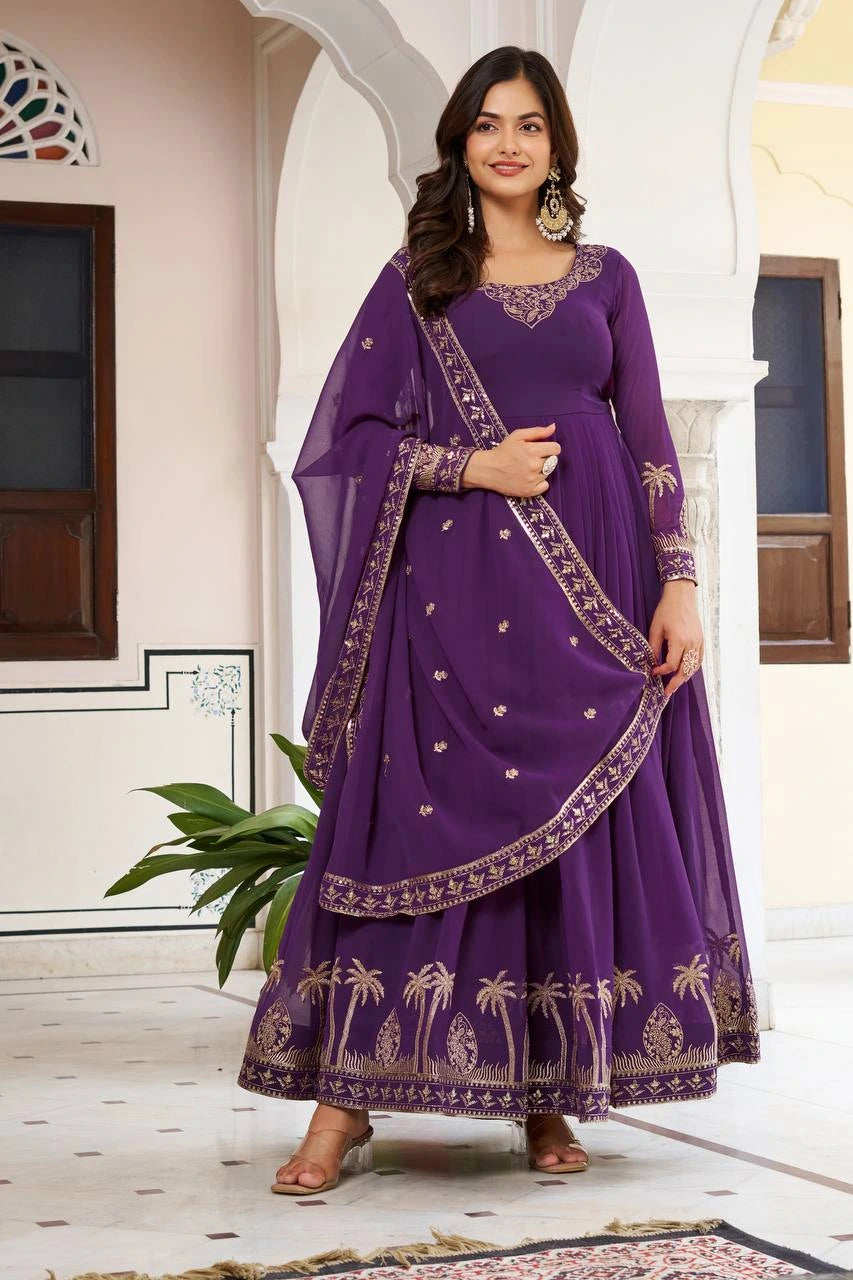 Woman wearing a purple embroidered traditional outfit in an architectural setting