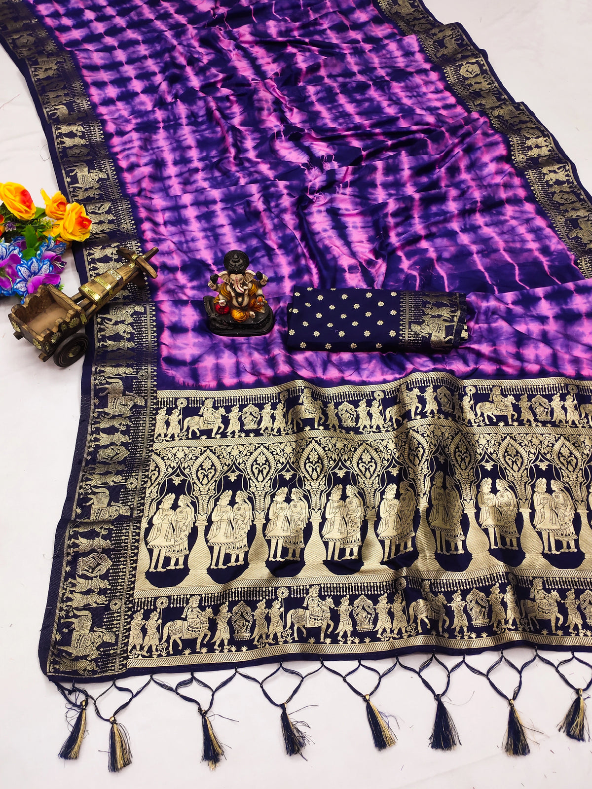 Purple and black patterned fabric with tassels on a white background