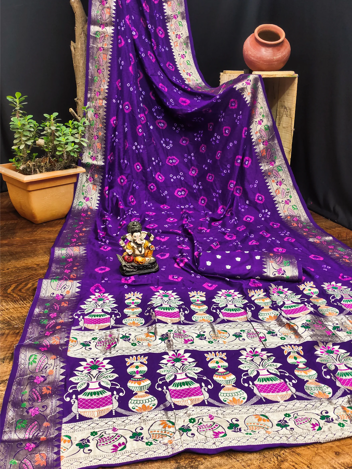 Purple saree with intricate patterns on a wooden surface