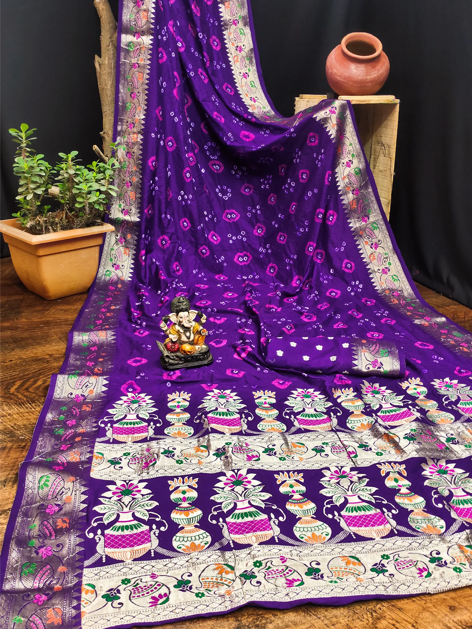 Purple saree with intricate patterns on a wooden surface