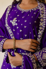 Purple embroidered garment with intricate patterns on a neutral background