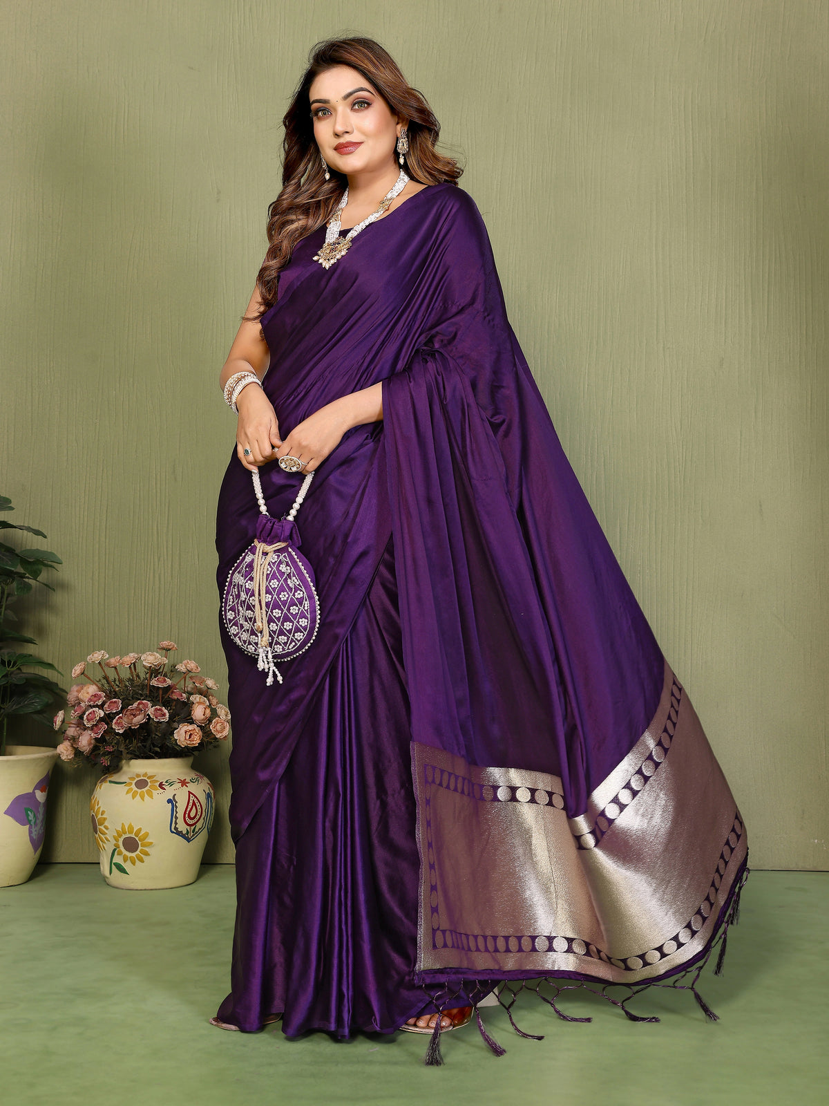 Woman in a purple saree with a green background