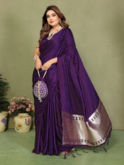 Woman in a purple saree with a green background