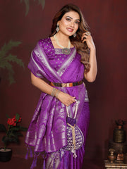 Woman in a purple saree with silver border against a dark background