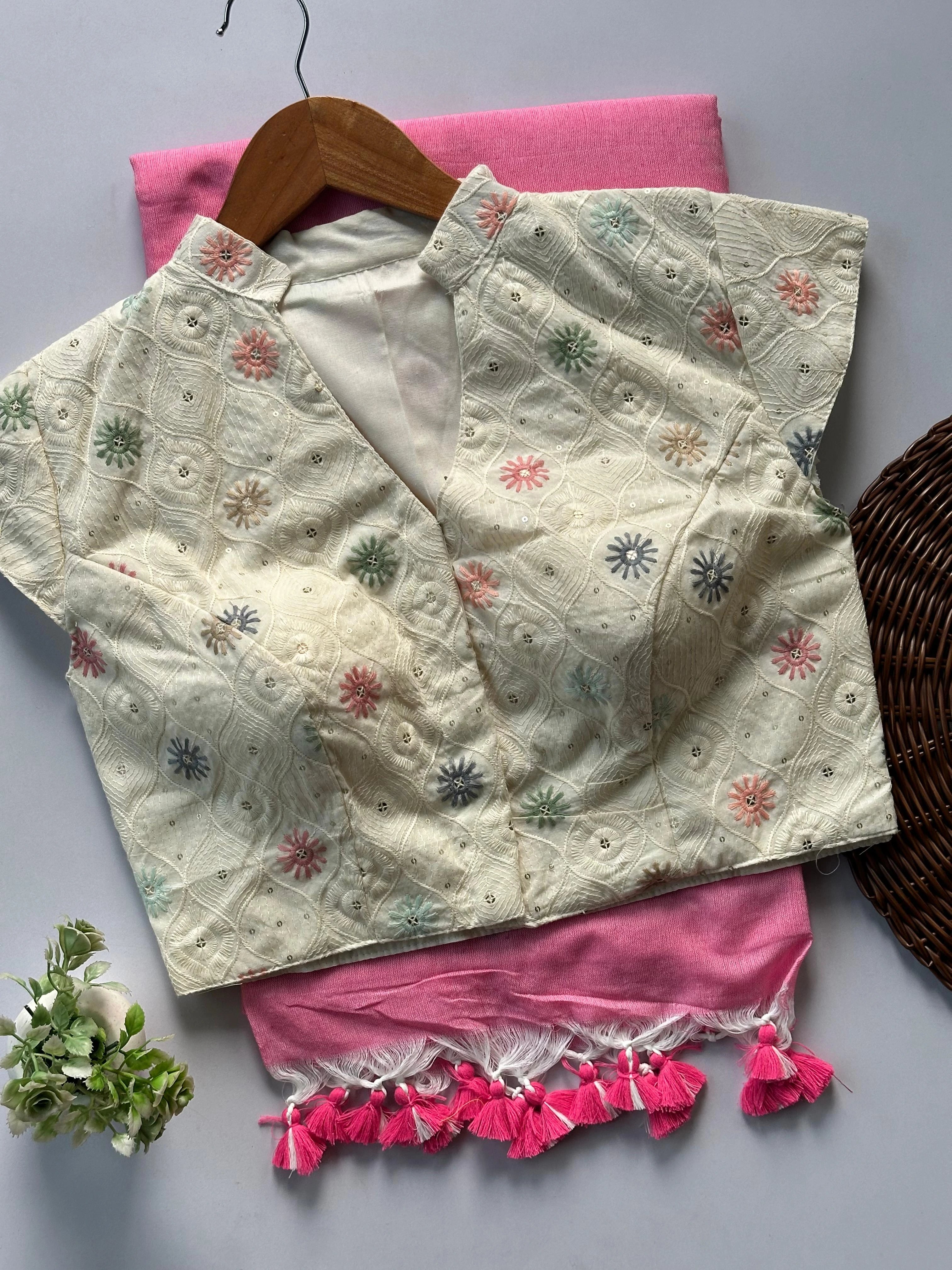 Embroidered blouse with floral patterns on a pink fabric background