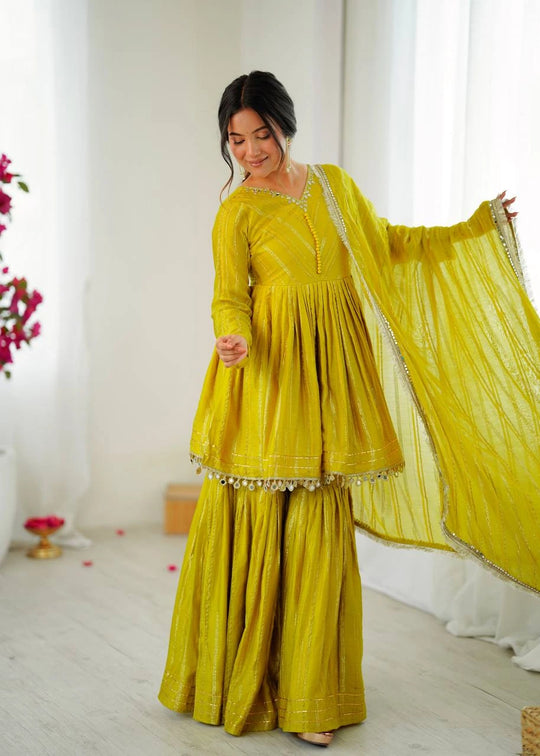 Woman wearing a yellow traditional outfit with a white background