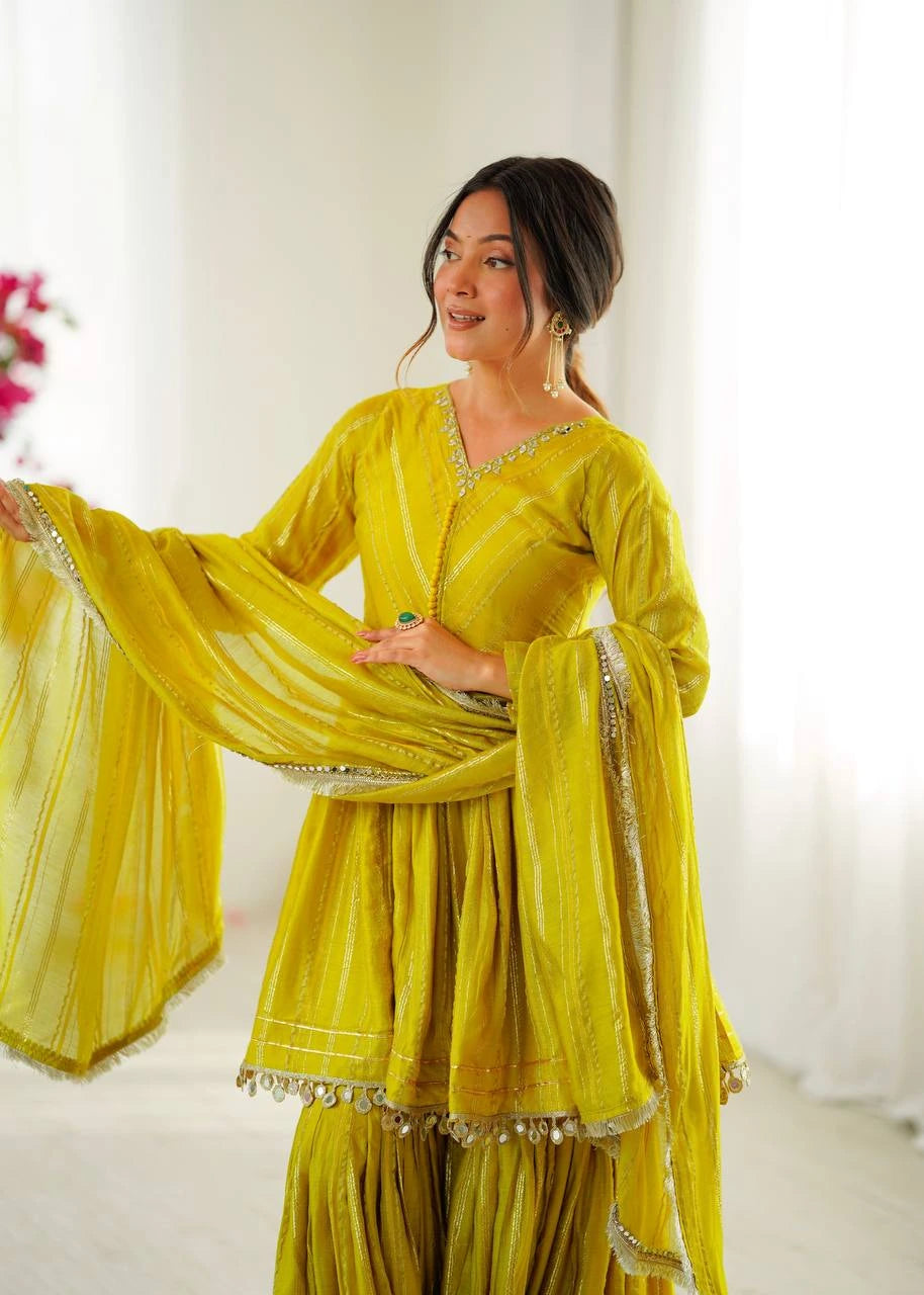 Woman wearing a yellow traditional outfit with a white background
