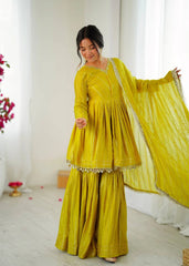 Woman wearing a yellow traditional outfit with a white background