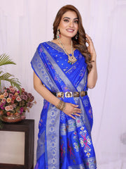Woman wearing a blue saree with a white background