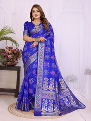 Woman wearing a blue saree with floral patterns in a room setting.