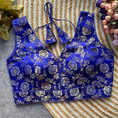 Blue floral brocade sports bra and panties set on a textured surface.