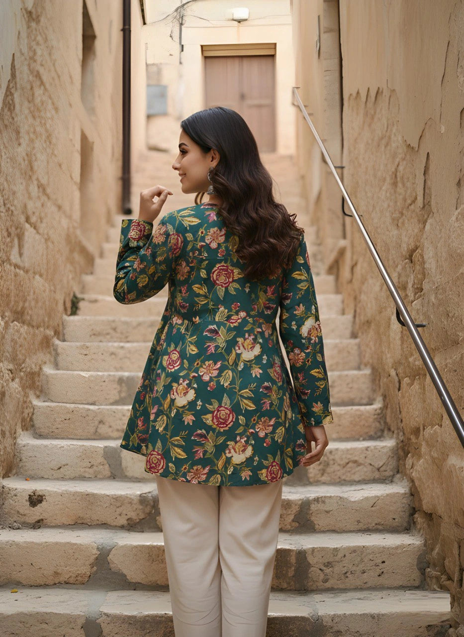 Woman in a floral jacket standing on stone steps in an alleyway.