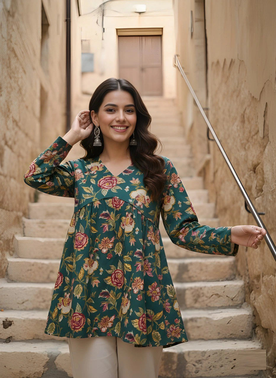 Woman in a floral dress standing on stone steps in an alleyway.