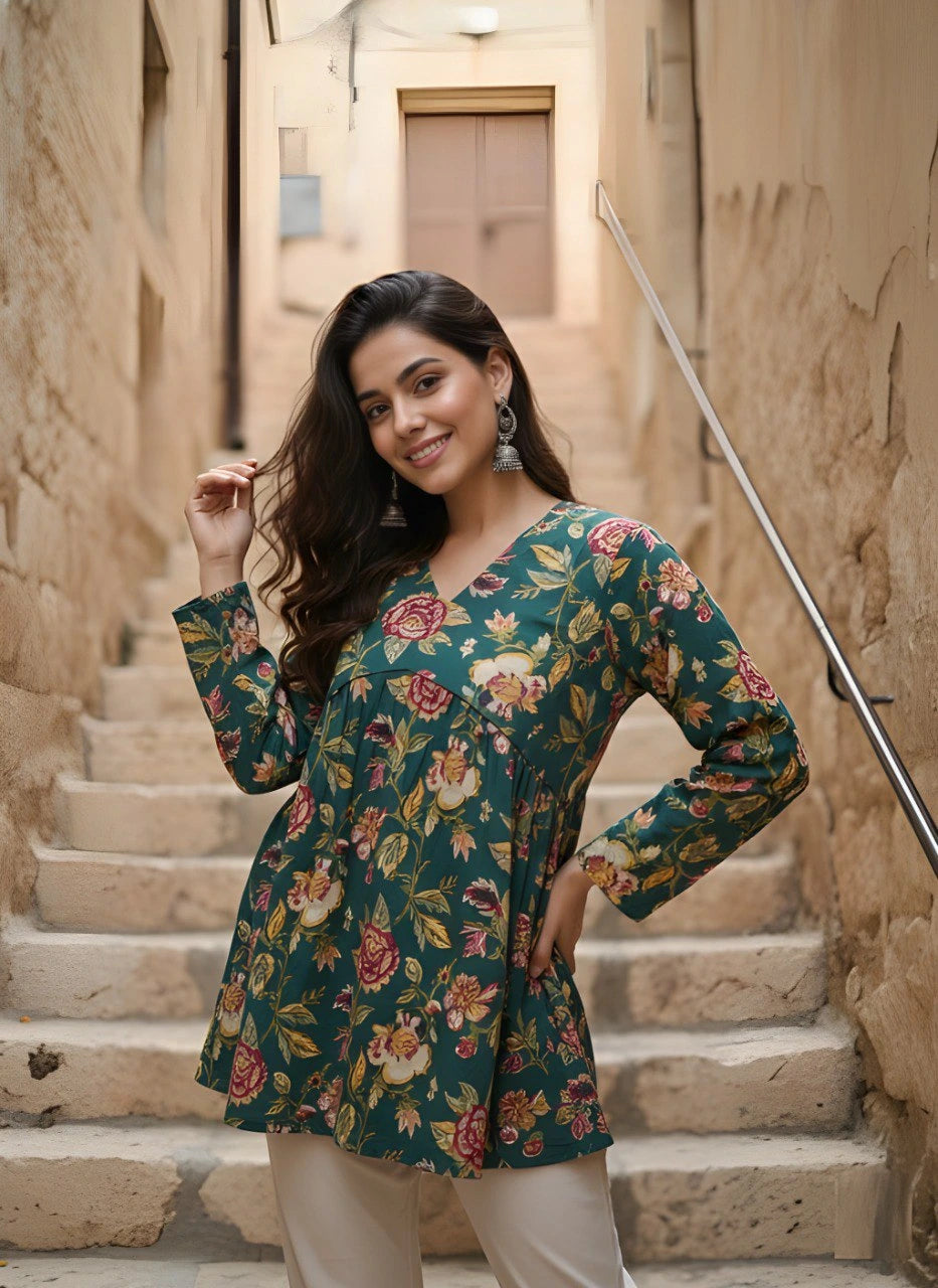 Woman in a floral dress standing on stone steps in an alleyway.