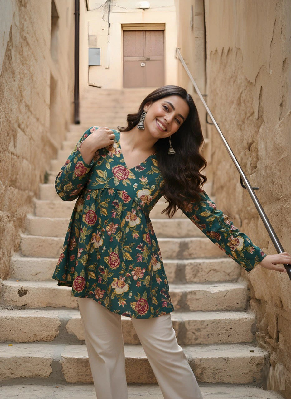 Woman in a floral dress standing on stone steps in an alleyway.