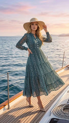 Woman in a green dress and sun hat on a boat at sunset