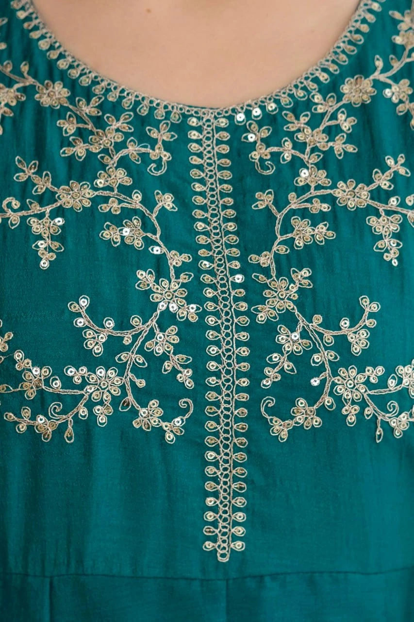 Teal dress with intricate silver embroidery