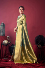 Woman in a gold saree standing against a red background