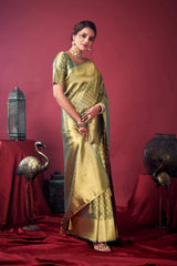 Woman in a green saree standing against a red background with decorative elements.