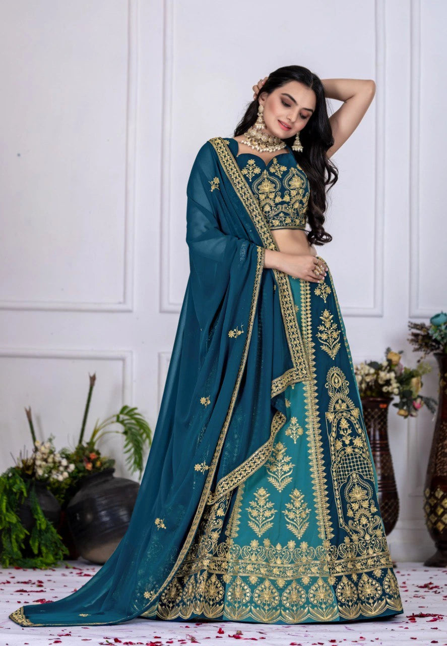 Woman in a teal and gold embroidered traditional outfit with a white background
