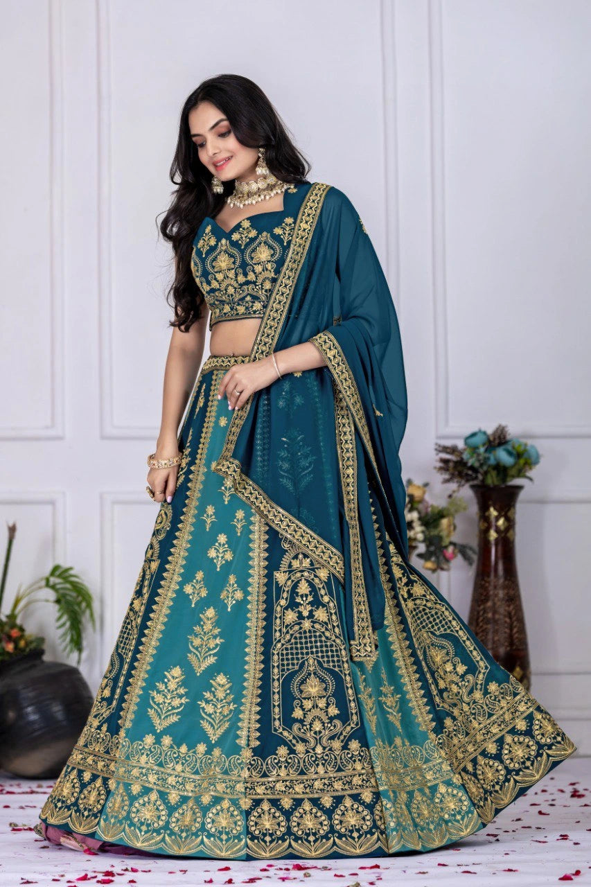 Woman wearing a teal and gold embroidered traditional outfit with a white background