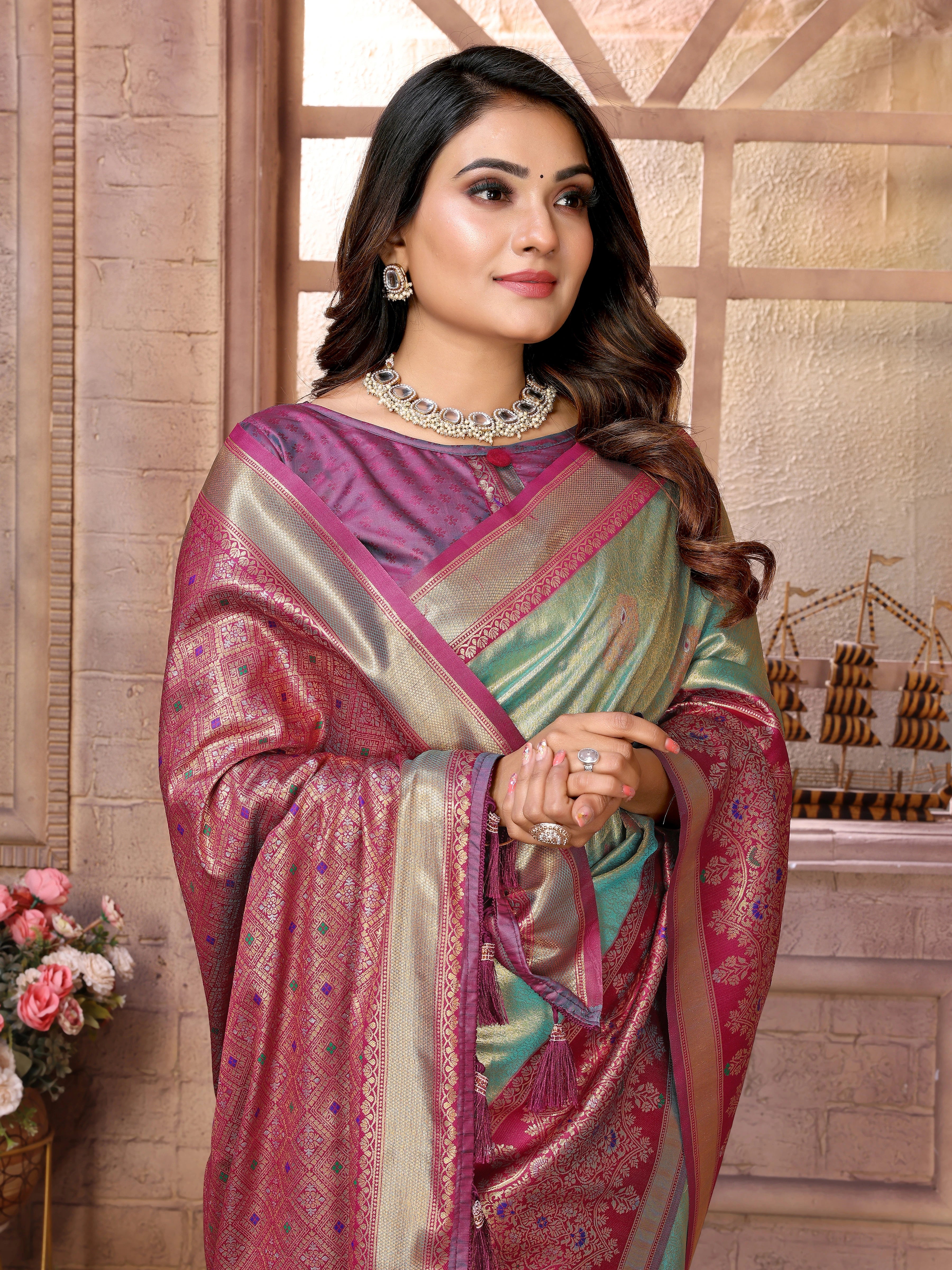 Woman wearing a traditional saree with a decorative background