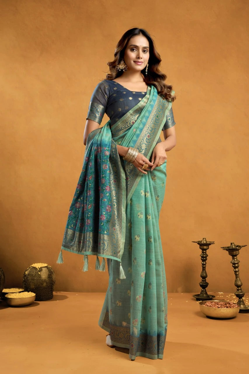 Woman in a teal saree with a brown background
