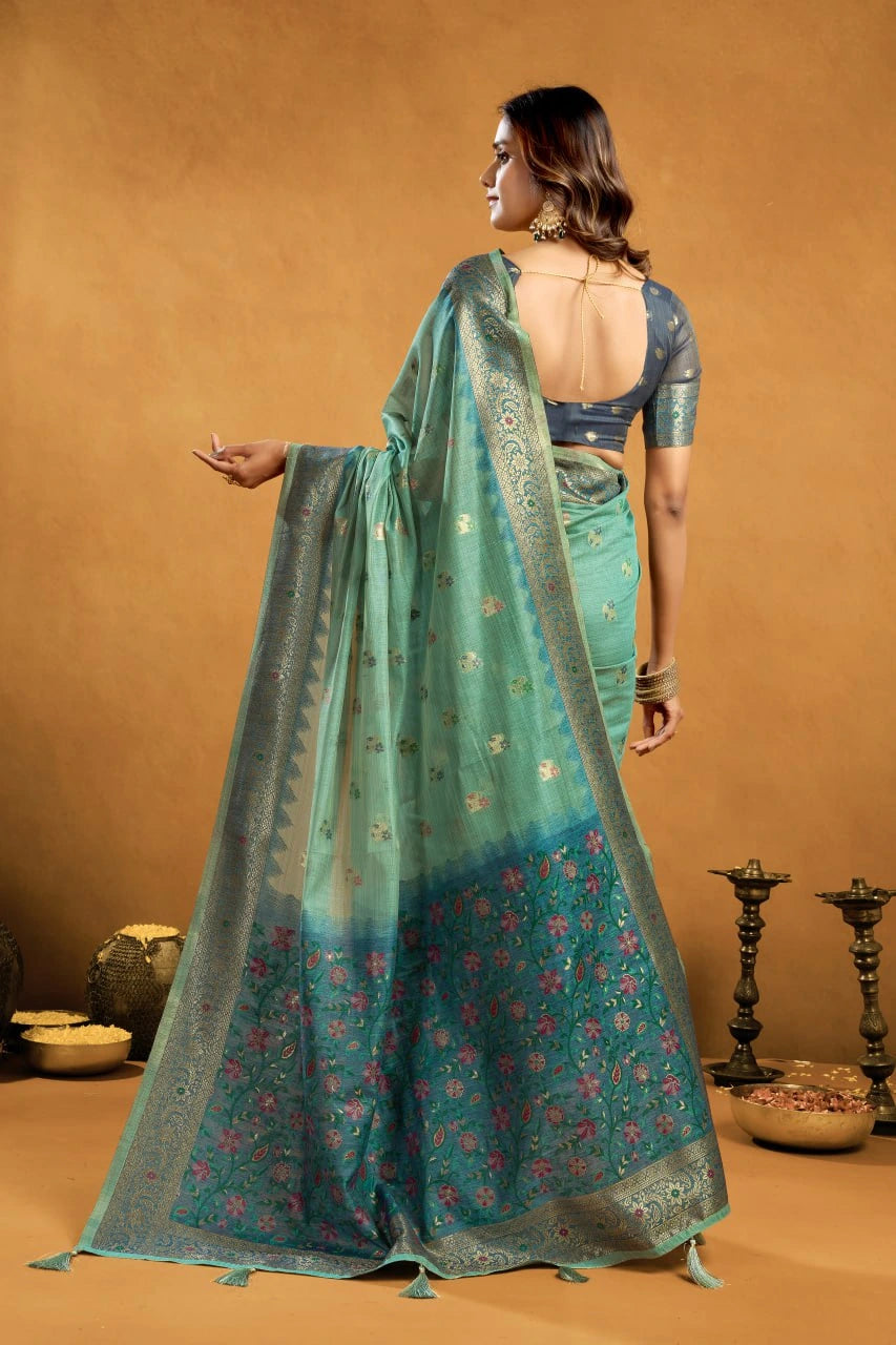 Woman wearing a green saree with a brown background