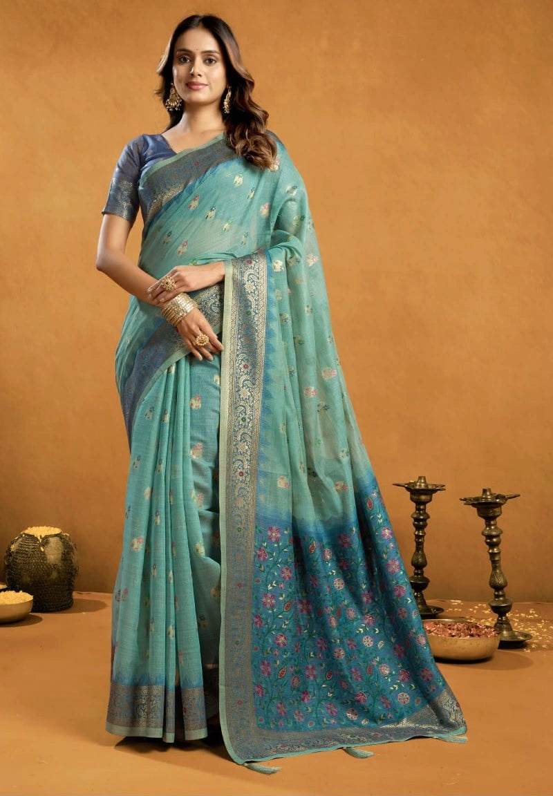 Woman wearing a teal saree with a brown background