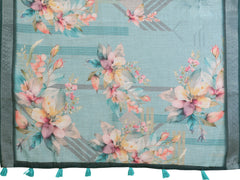 Flat lay of Tropical Green Digital Floral Print Linen Cotton Saree showing full fabric with botanical florals and contrast border with teal tassels