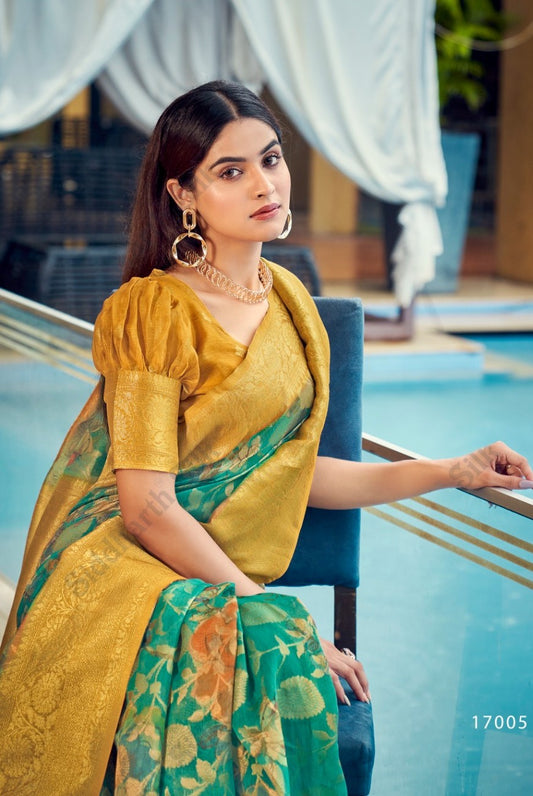 Woman in a tropical green zari work saree with floral patterns and golden pallu, styled elegantly with statement jewelry by the poolside