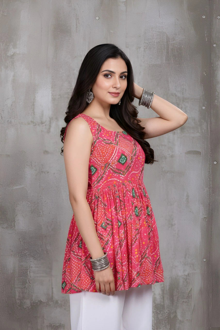 Woman wearing a pink patterned top against a gray background