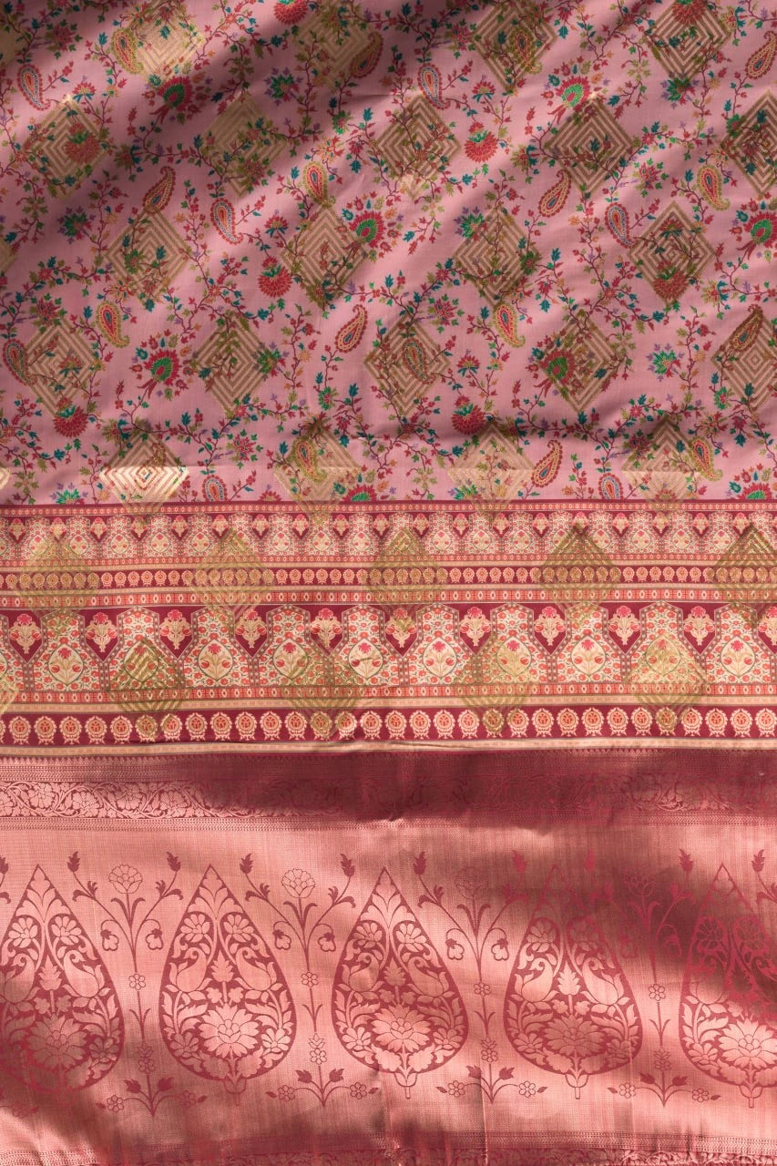 Pink fabric with intricate patterns and border design