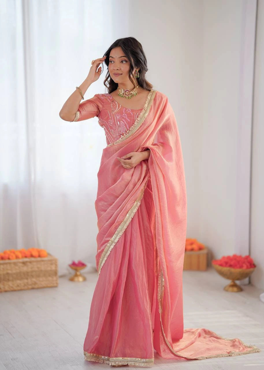 Woman wearing a pink saree with a white background