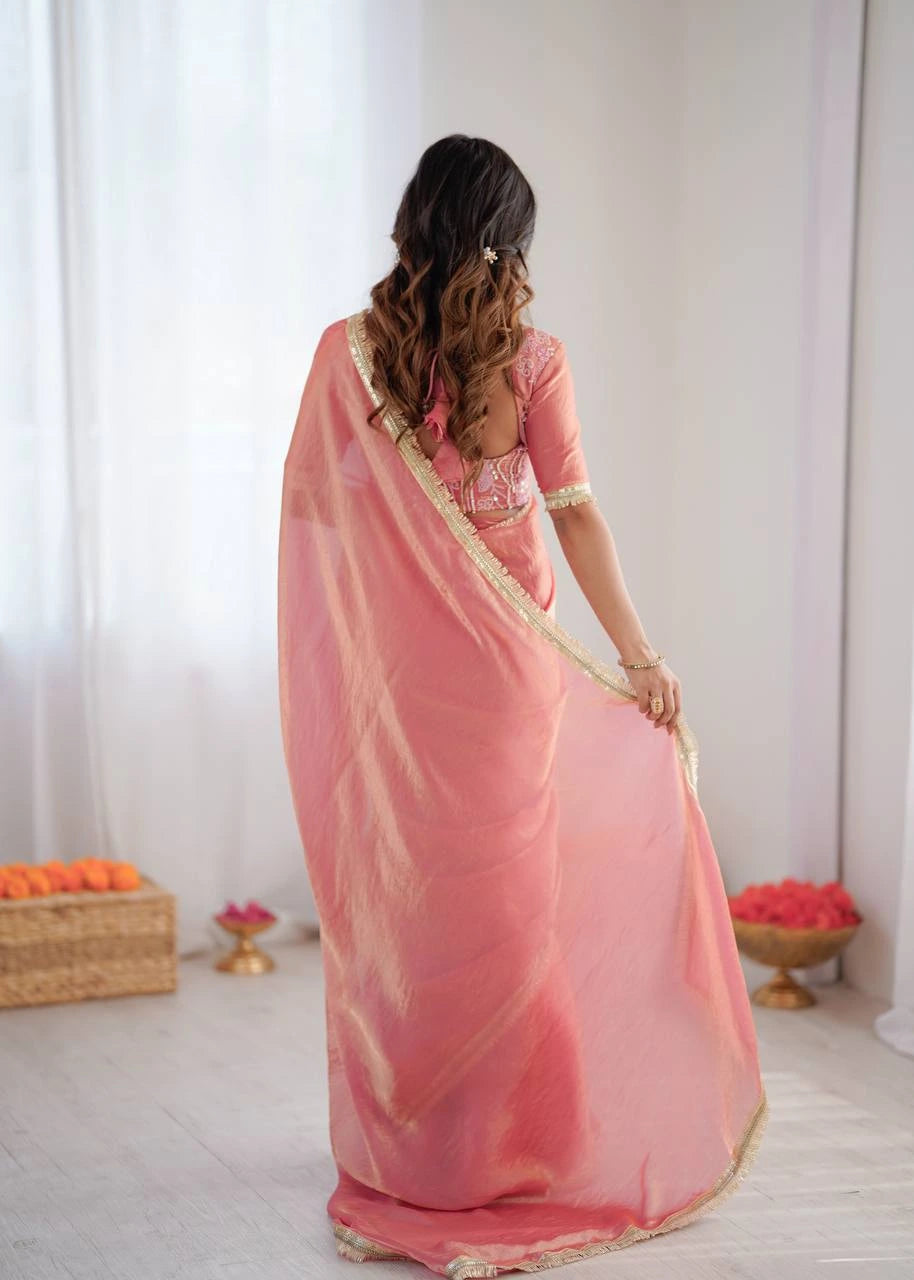 Woman wearing a pink saree with a white background