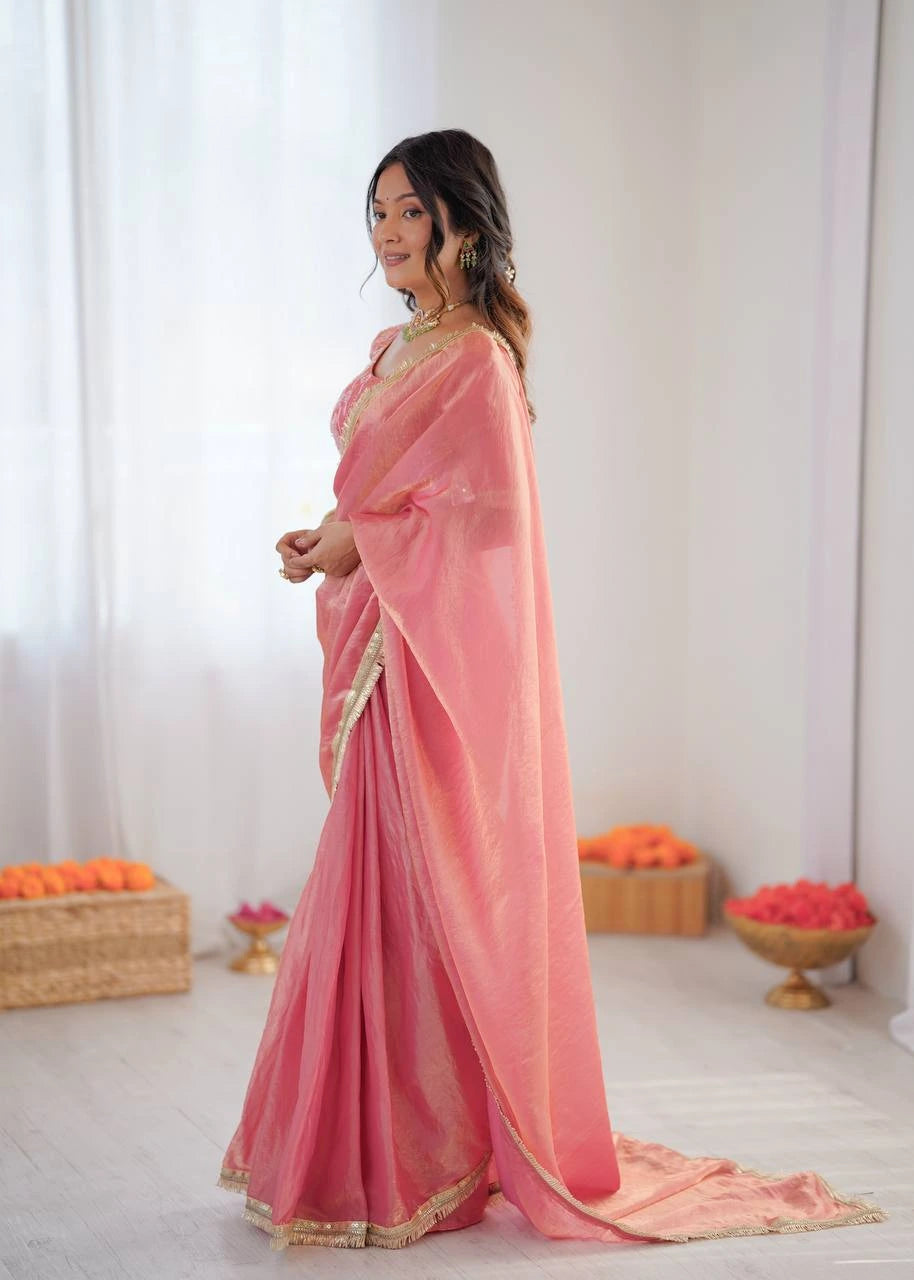 Woman wearing a pink saree with a white background